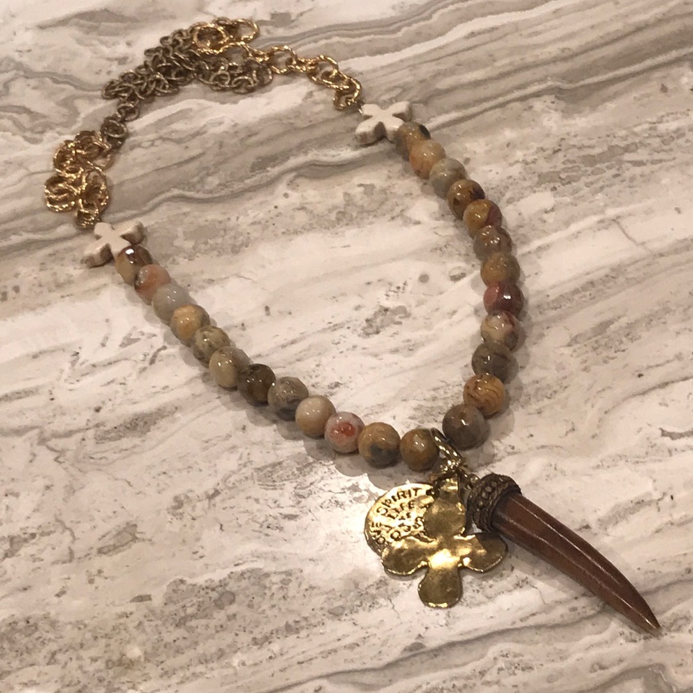 Long beaded necklace. Cross and horn pendants